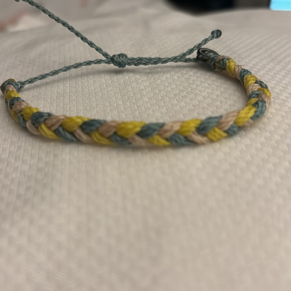 - Pura vida yellow white and blue braided bracelet